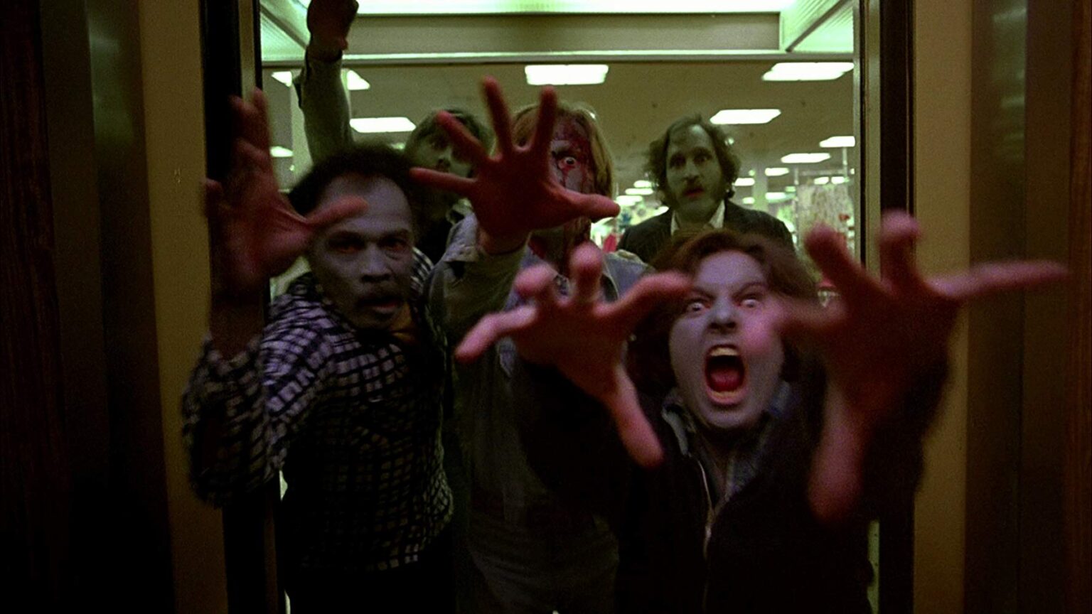 Gli Zombi escono da un'ascensore, nel film di Romero
